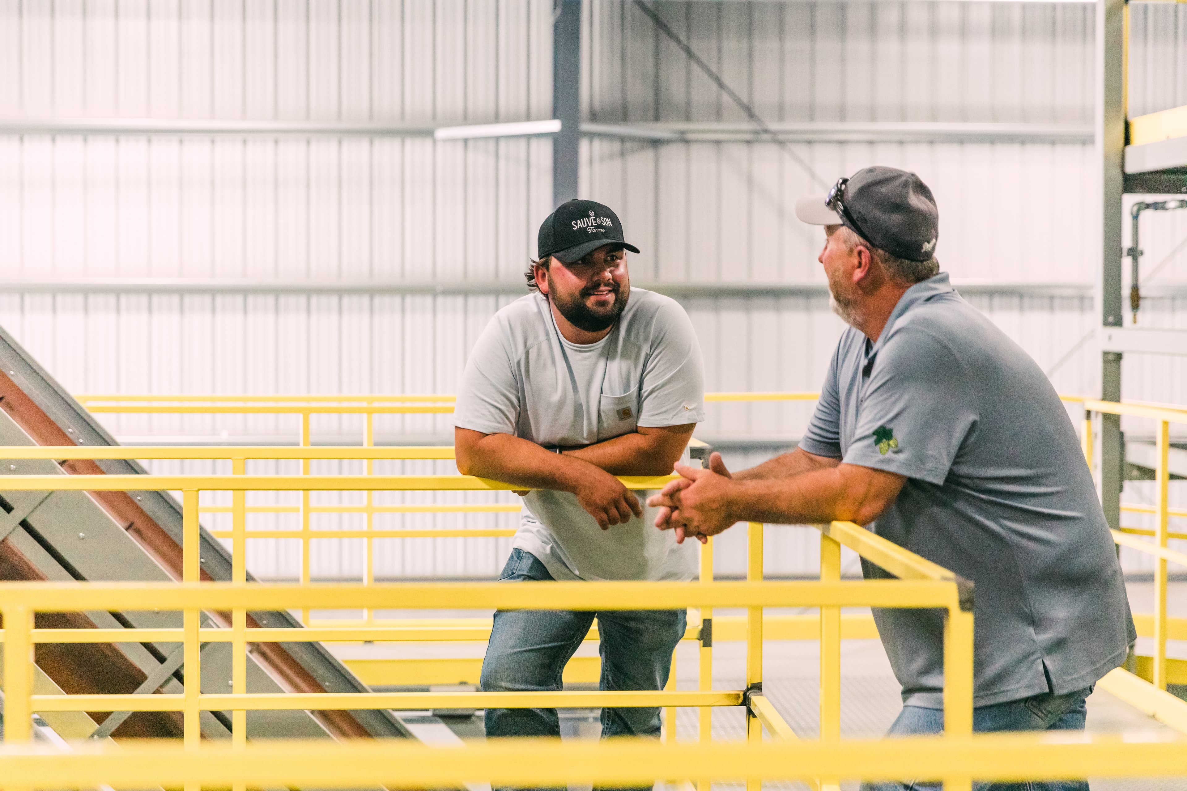 Two farmers talking to each other in picking facility